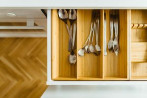 High quality photo of a drawer with forks and spoons inside it at a home on the island. 